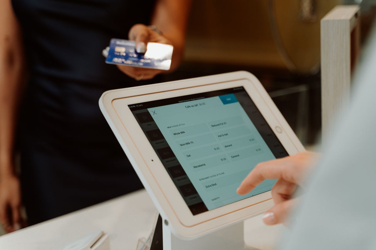 about-us-02 A modern cashless payment system using a tablet and card for seamless transactions.